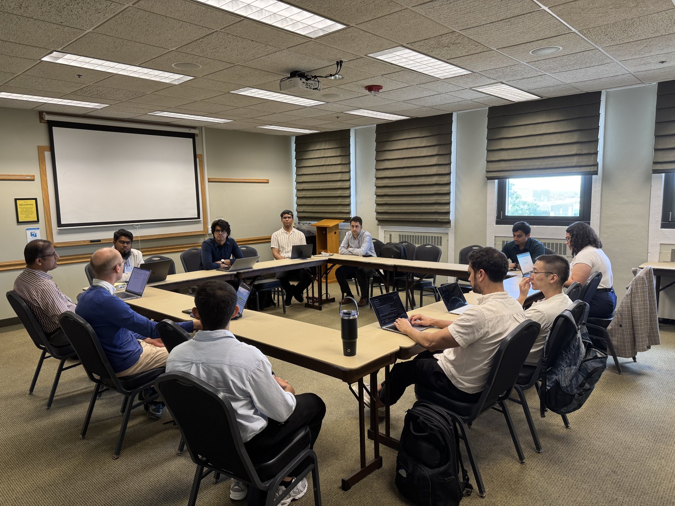 Workshop participants exchanging ideas around a table during a breakout session.