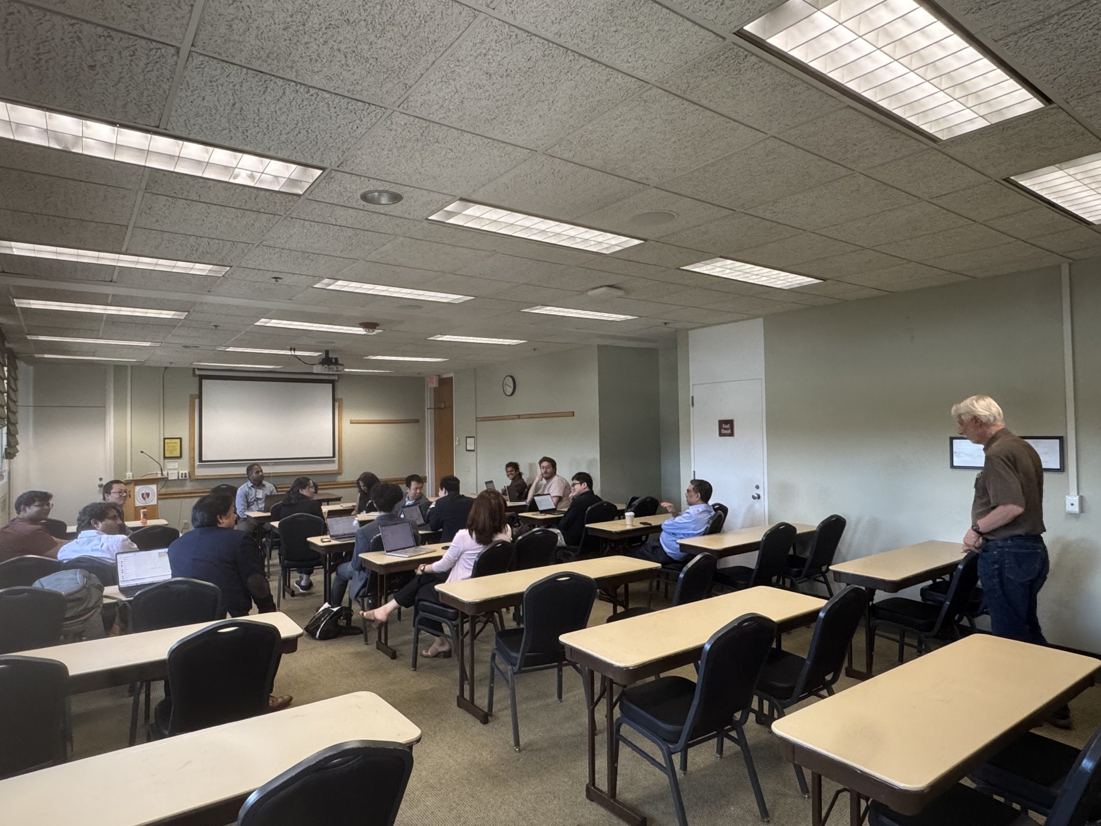 Attendees seated around tables during a breakout discussion.